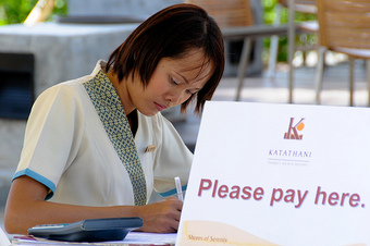 A cashier at a hotel in Thailand