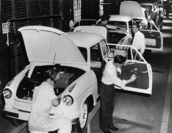 Workers working together on an assembly line