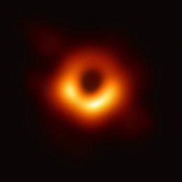Blackness of space with black marked as center of donut of orange and red gases