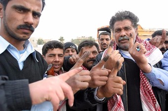 Iraqi police show of their ink-stained index fingers – proof that they visited the polls to cast their ballot in Iraq’s historic parliamentary elections in 2005, photo by  Jim Goodwin. 