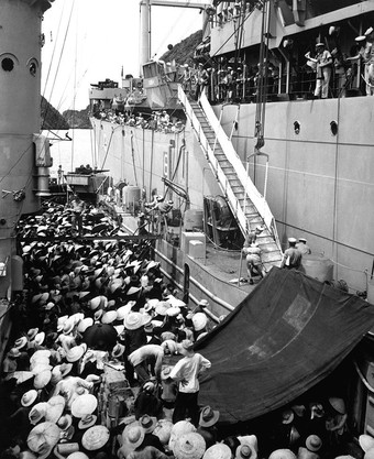  Anticommunist Vietnamese refugees moving from a French LSM landing ship to the USS Montague during Operation Passage to Freedom in August 1954, photo by H.S. Hemphill.   