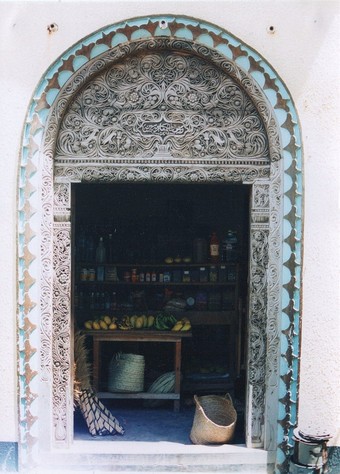  Swahili Arabic script on a carved wooden door (open) at Lamu in Kenya        