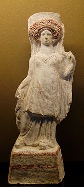 Standing woman holding her veil. Terracotta figurine, c. 400–375 BC